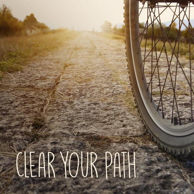 Picture of bike riding along a path with text saying "clear your path"