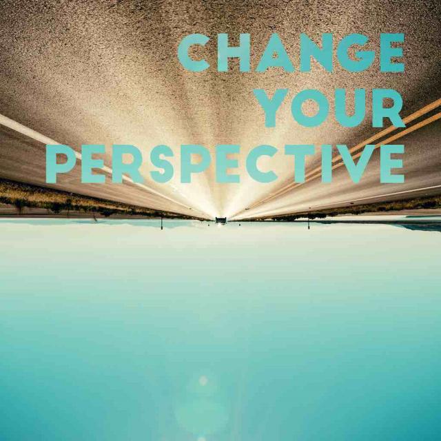 upside down image of horizon in the distance with text stating change your perspective